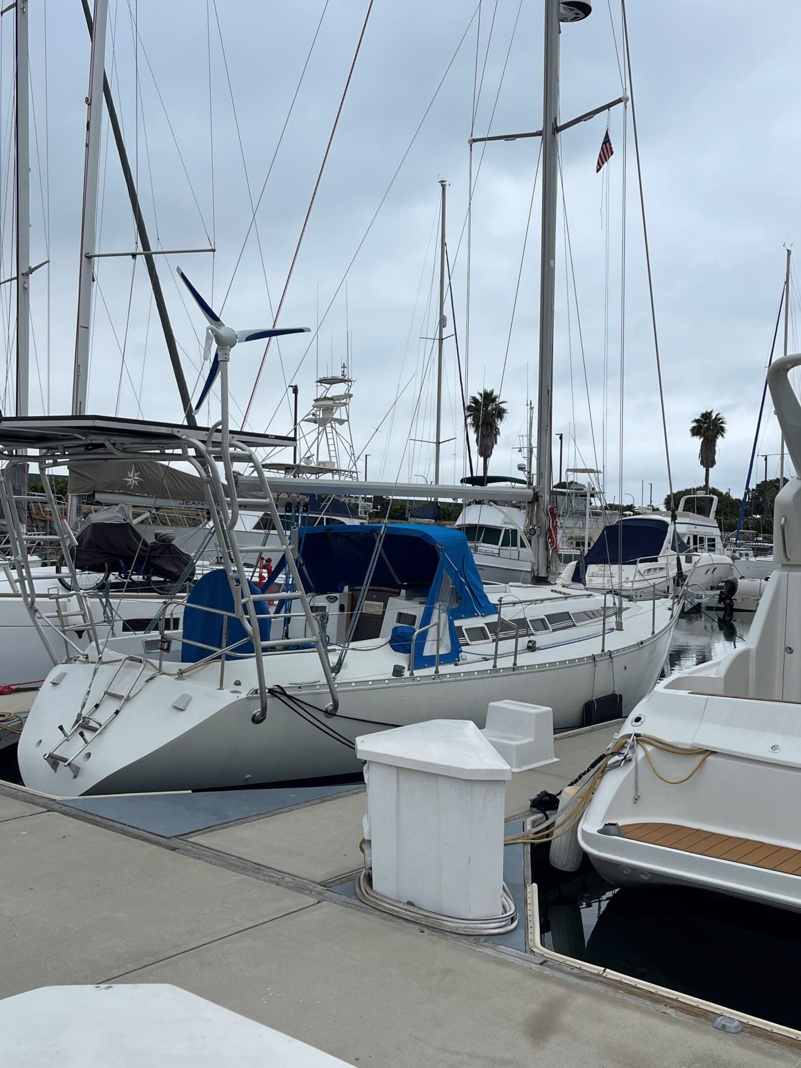 A boat yard with many boats parked on the dock.